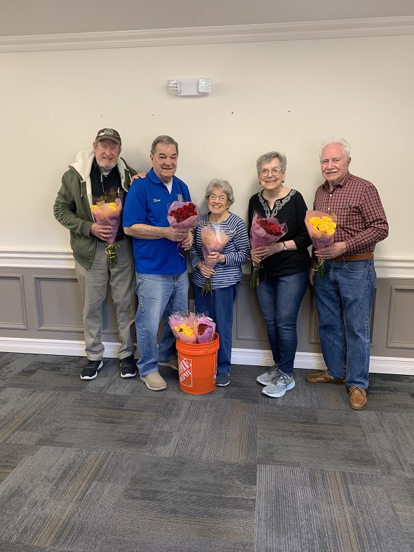 Photo by Kathe Leon-McHugh: Warwick Rotarians Chris Olert and Stan Martin, left, deliver long-stemmed roses to Liberty Green senior residents Wanda McDowell, Nancy Brandt and Mike DiCaprio.