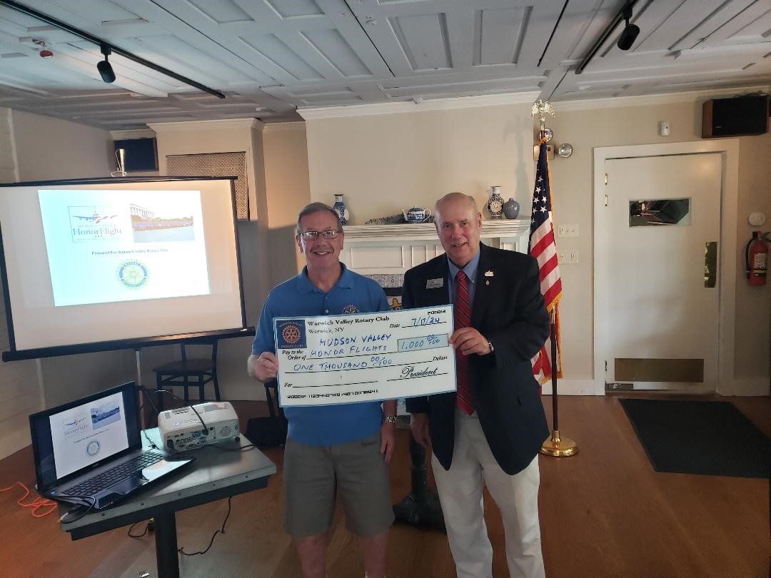 Neil Sinclair, left, who completed his fourth term as Warwick Valley Rotary Club president on June 30, presents a $1,000 donation check to Bill Sestrom, a former Newburgh Rotary Club president and charter board member of the Hudson Valley Honor Flight. Photo by Jim LaPlante