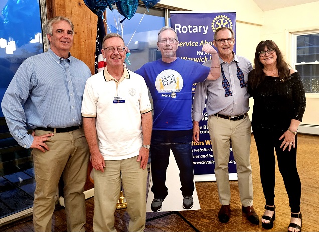 Photo: (L-R) Leo R. Kaytes, District Governor, Neil Sinclair, outgoing President (Neil in cardboard) David & Patti Dempster
